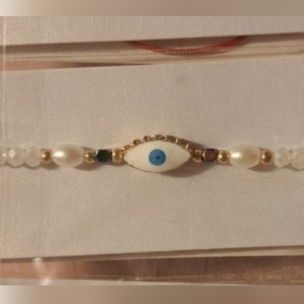 Evil Eye Bracelet Made of beads pearls adjustable band NEW in package.